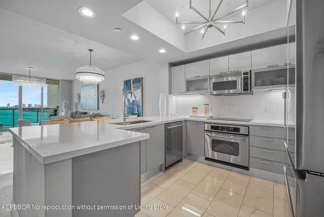 a kitchen with kitchen island a sink stainless steel appliances and cabinets