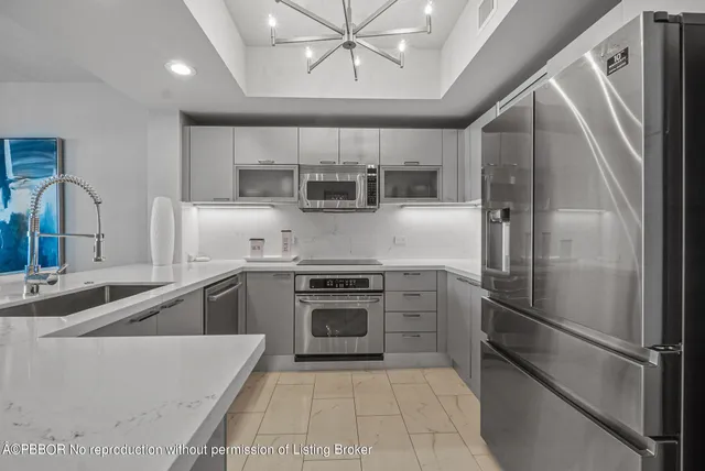a kitchen with a refrigerator sink and cabinets