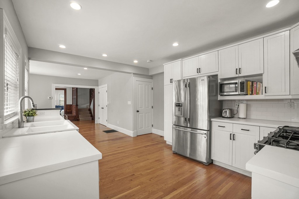 655 Washington Street, Unit 655 Brookline, MA 02446 - Photo 11 of 26 a kitchen with stainless steel appliances a refrigerator sink and cabinets