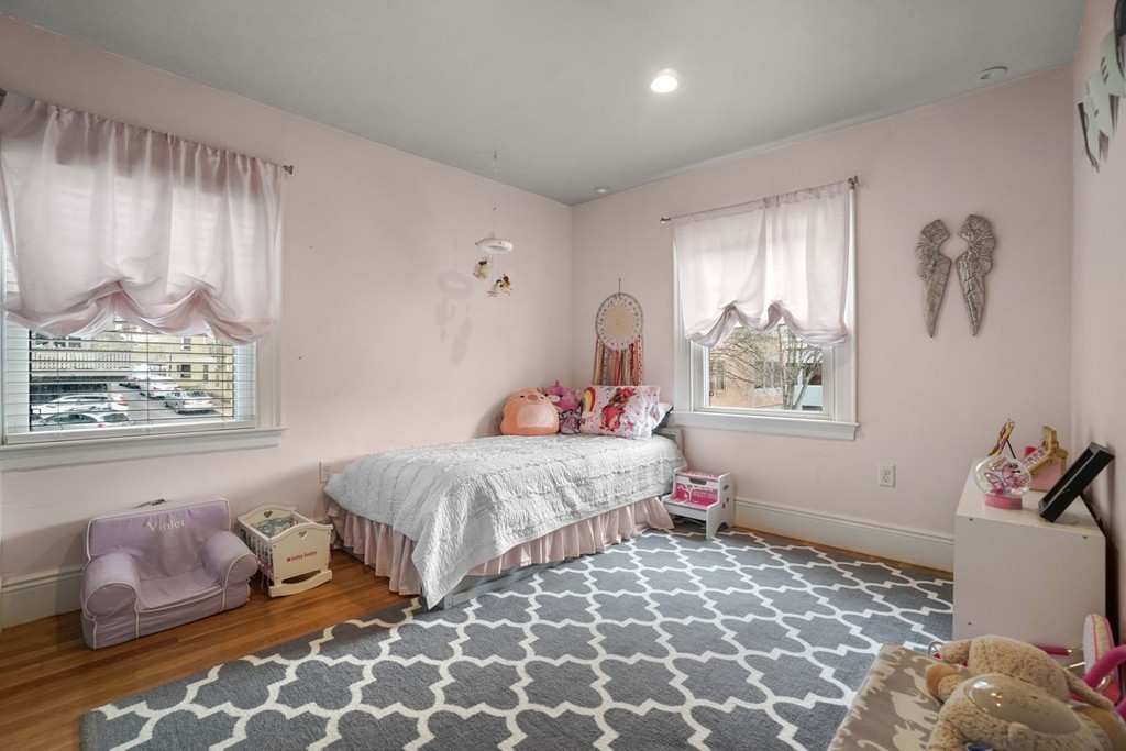 655 Washington Street, Unit 655 Brookline, MA 02446 - Photo 17 of 26 a bedroom with a bed and a window