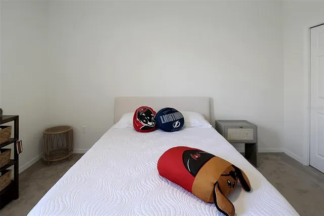 a bedroom with two beds and a ceiling fan