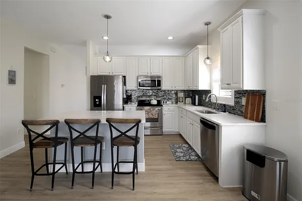 a kitchen with a refrigerator stove and sink