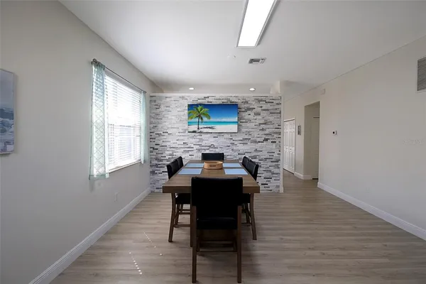 a view of a dining room with furniture and wooden floor
