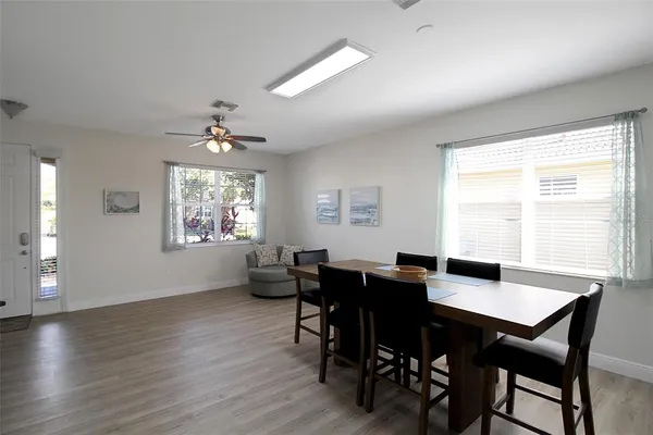 a view of a hallway with wooden floor windows and plants