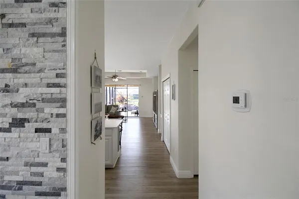 a view of a hallway with wooden floor and closet