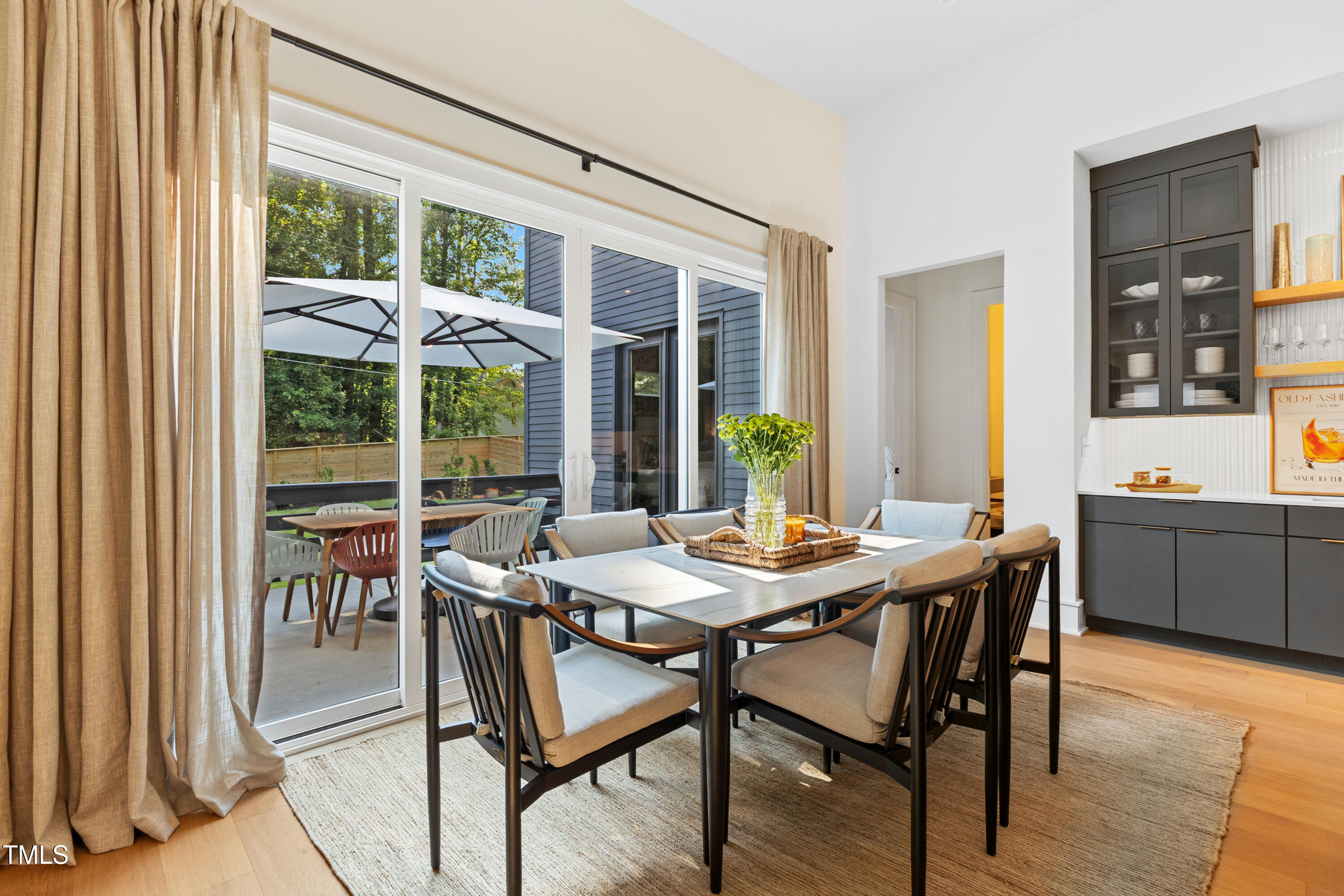 1625 Bruce Circle Raleigh, NC 27603 - Photo 13 of 63 a view of a dining room with furniture large windows and wooden floor