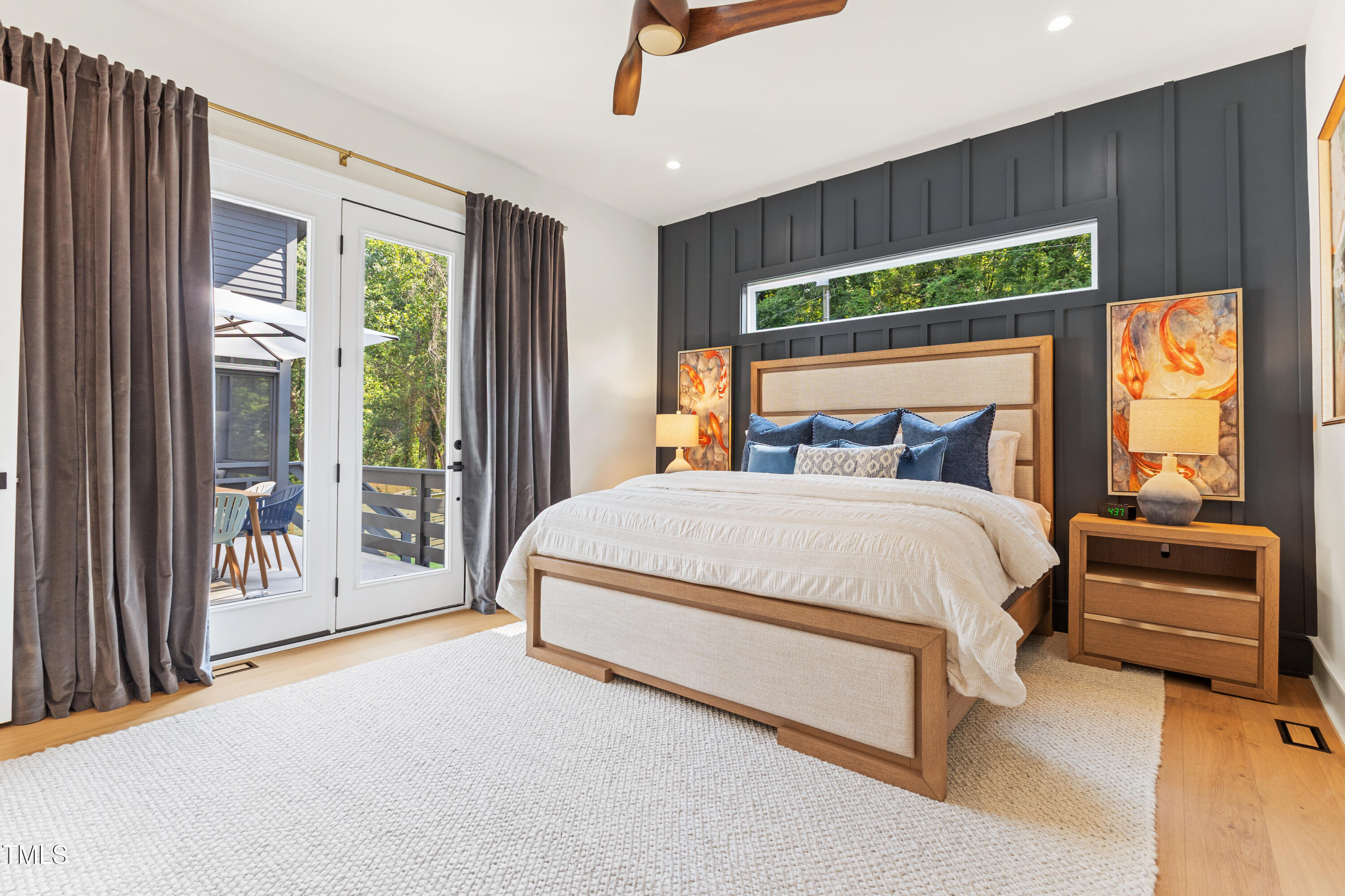 1625 Bruce Circle Raleigh, NC 27603 - Photo 30 of 63 a bedroom with a bed lamp and a large window with balcony view