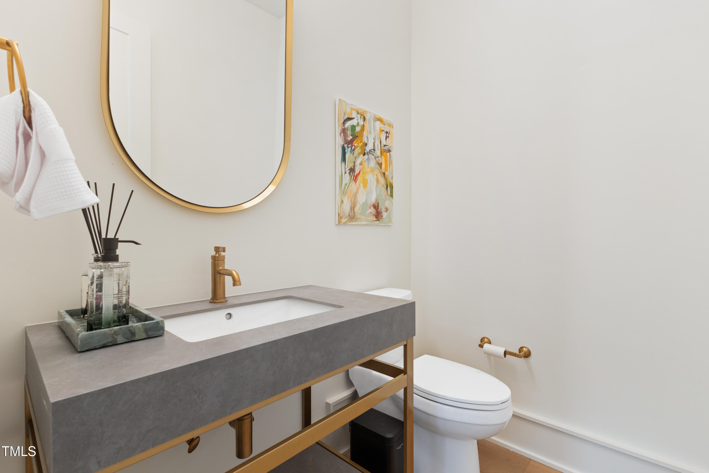 1625 Bruce Circle Raleigh, NC 27603 - Photo 41 of 63 a bathroom with a sink a toilet and a mirror