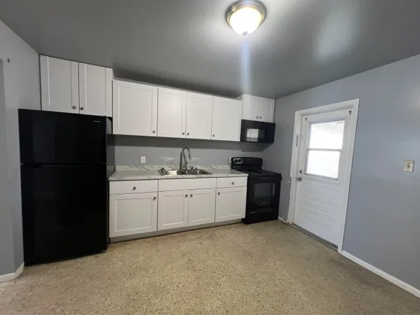 a bathroom with a toilet a sink and bathtub