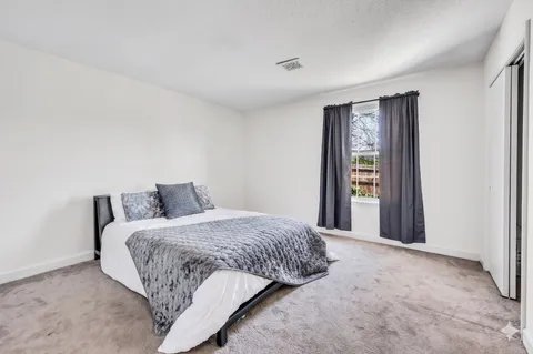 a bed room with a bed and a mirror