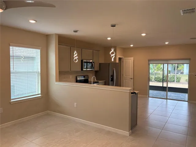 a kitchen that has a sink and stainless steel appliances