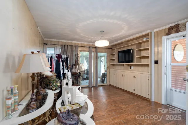 a view of a livingroom with furniture and a flat screen tv