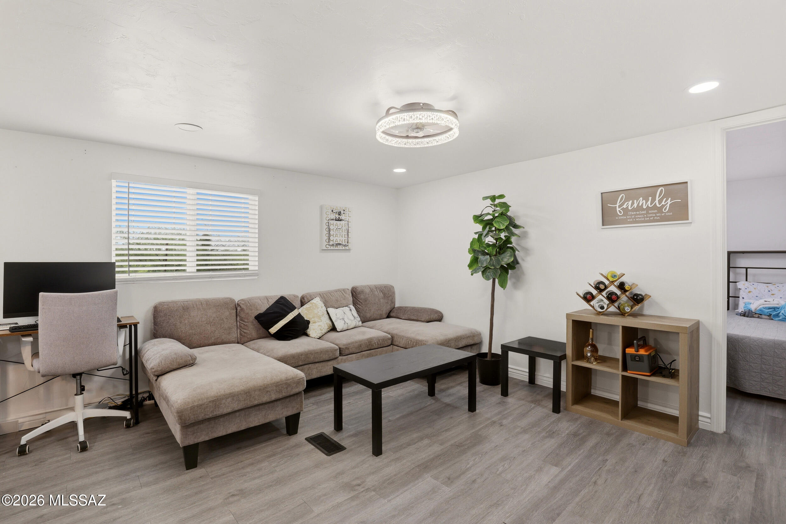 8620 South Sandario Road Tucson, AZ 85736 - Photo 8 of 26 a living room with furniture and wooden floor
