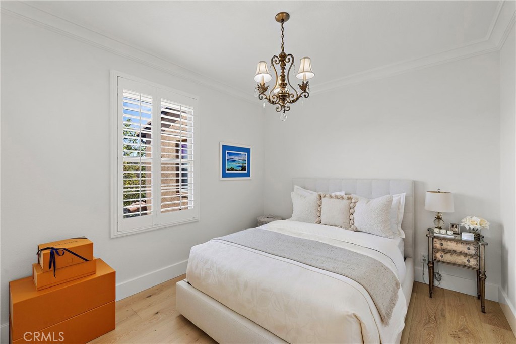 28 Tuscany Ladera Ranch, CA 92694 - Photo 30 of 47 a bedroom with a bed and a chandelier