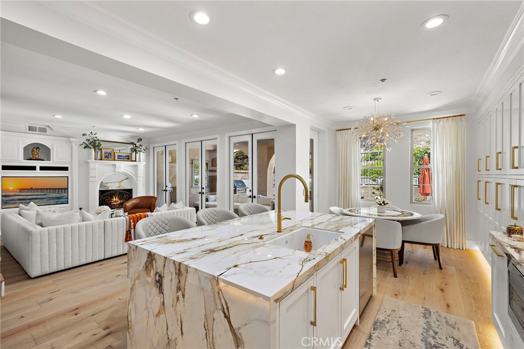 28 Tuscany Ladera Ranch, CA 92694 - Photo 9 of 47 a room with stainless steel appliances kitchen island granite countertop a sink and white cabinets with wooden floor