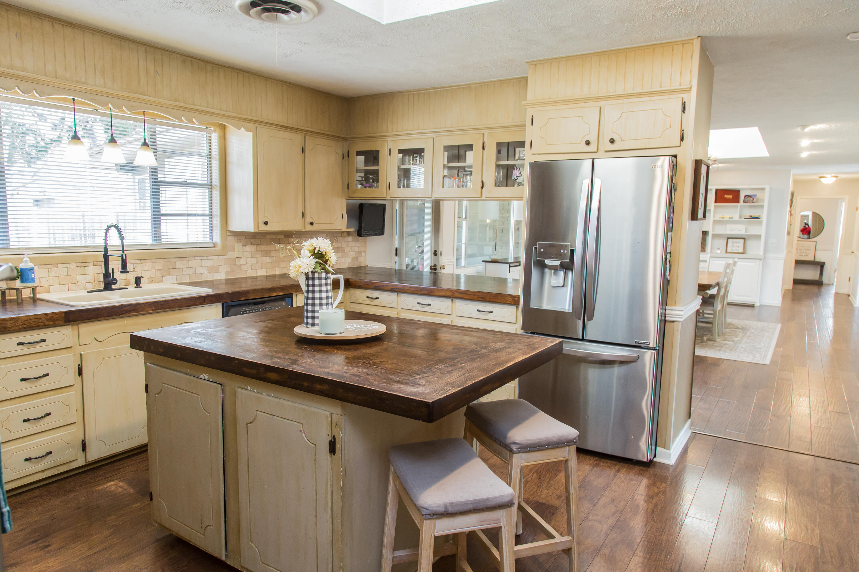 1106 Amarillo Plainview, TX 79072 - Photo 27 of 61 a kitchen with stainless steel appliances granite countertop a sink a refrigerator and wooden cabinets