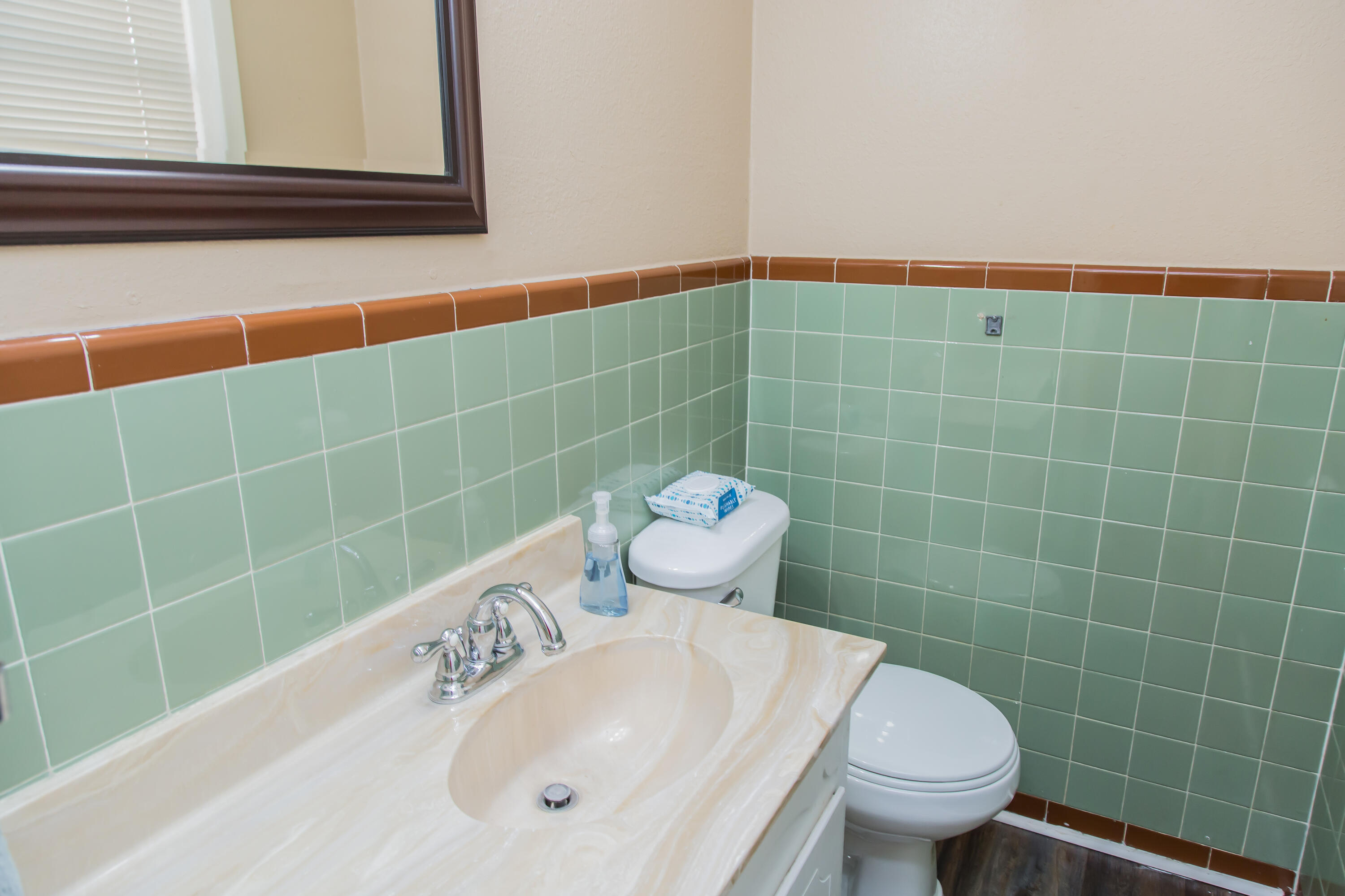 1106 Amarillo Plainview, TX 79072 - Photo 32 of 61 a bathroom with a sink a toilet and a mirror