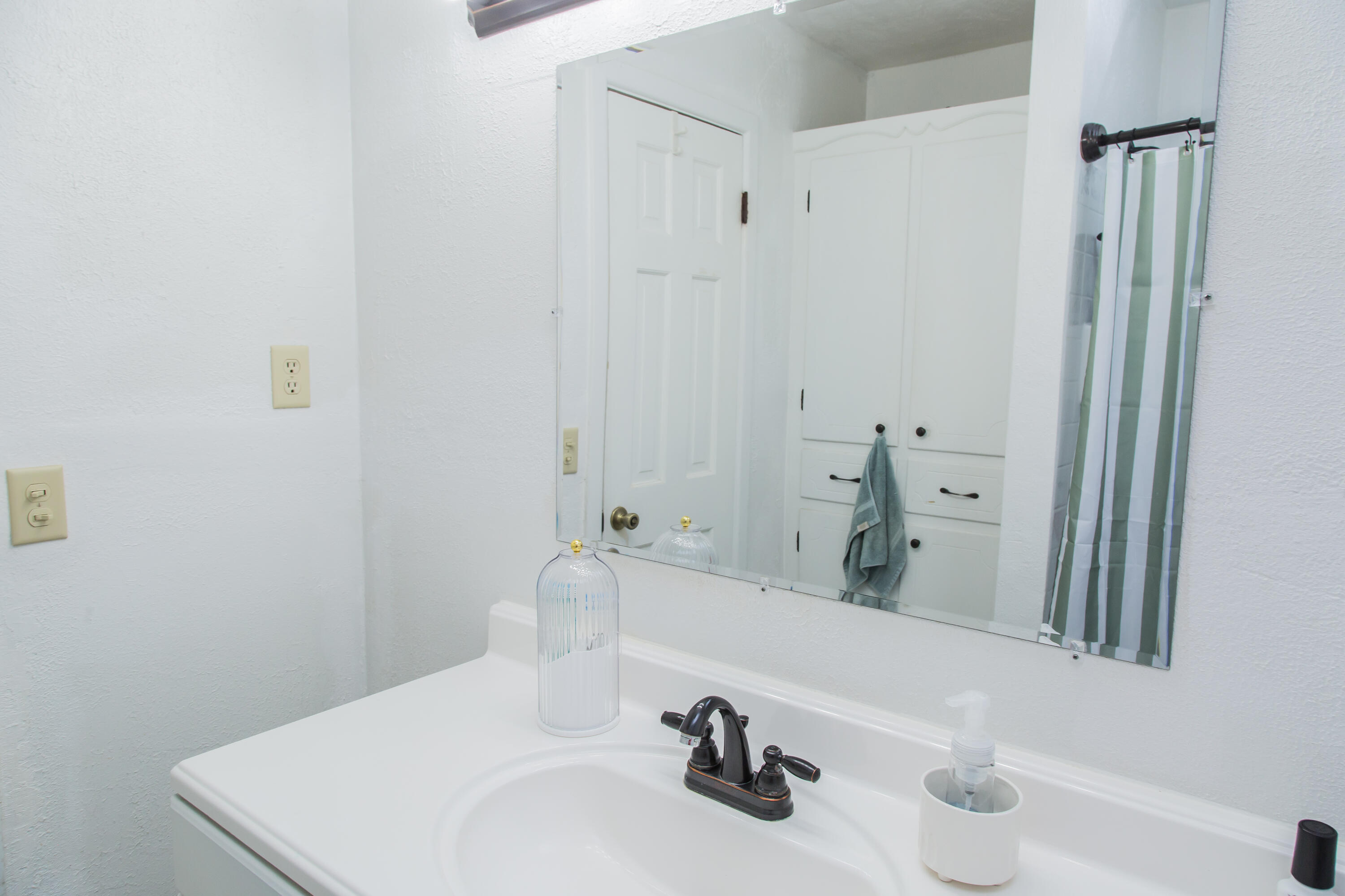 1106 Amarillo Plainview, TX 79072 - Photo 52 of 61 a bathroom with a sink and a mirror