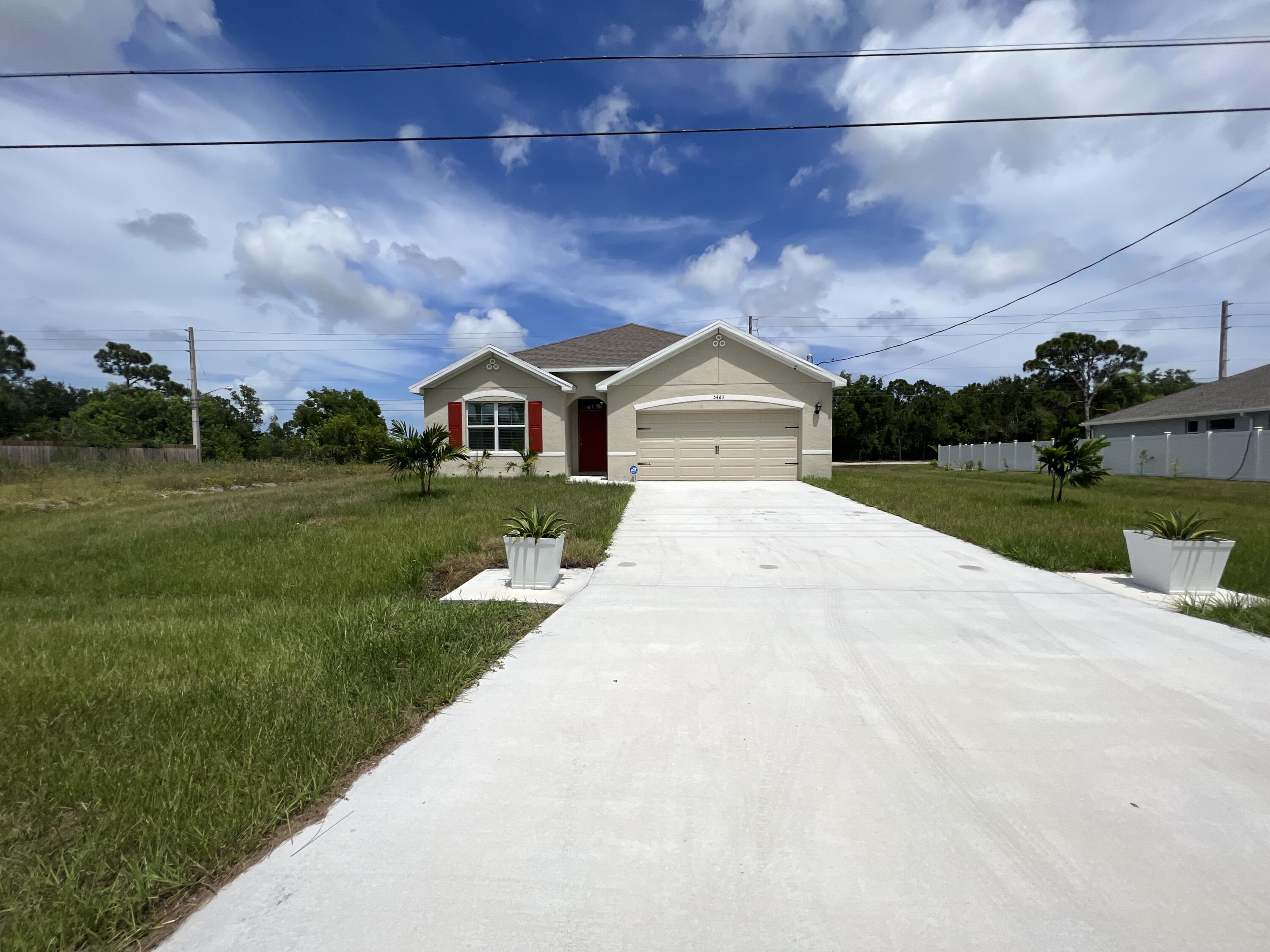 5463 Northwest Norris Avenue Port St. Lucie, FL 34986 - Photo 1 of 28 a front view of a house with a yard