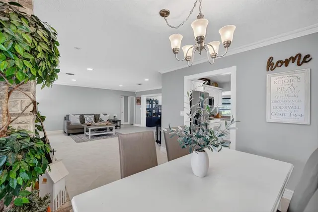 a kitchen with stainless steel appliances granite countertop a refrigerator sink and white cabinets