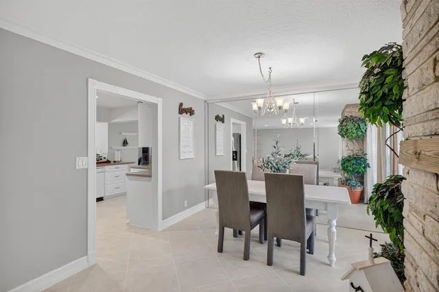 a bedroom with a chair and a chandelier
