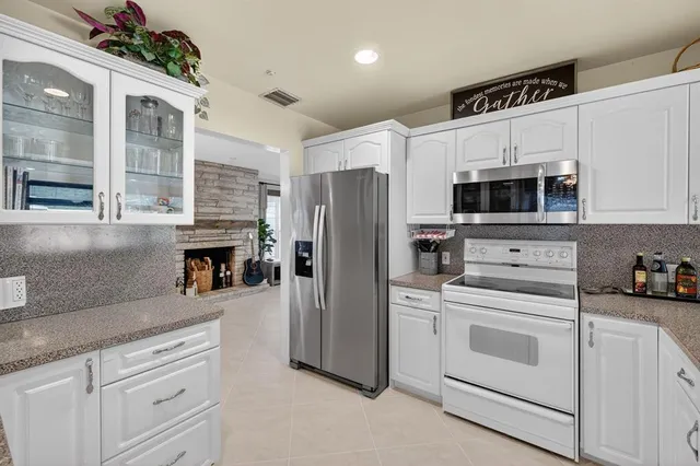 a kitchen with stainless steel appliances granite countertop a stove and a refrigerator