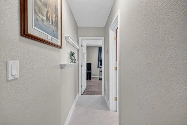 a bedroom with a bed a table and a window