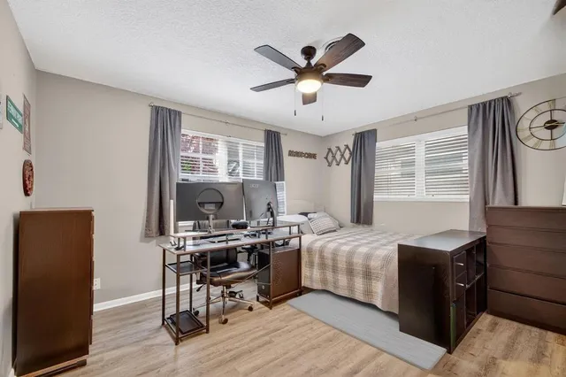 a view of a dining room with furniture a chandelier and wooden floor