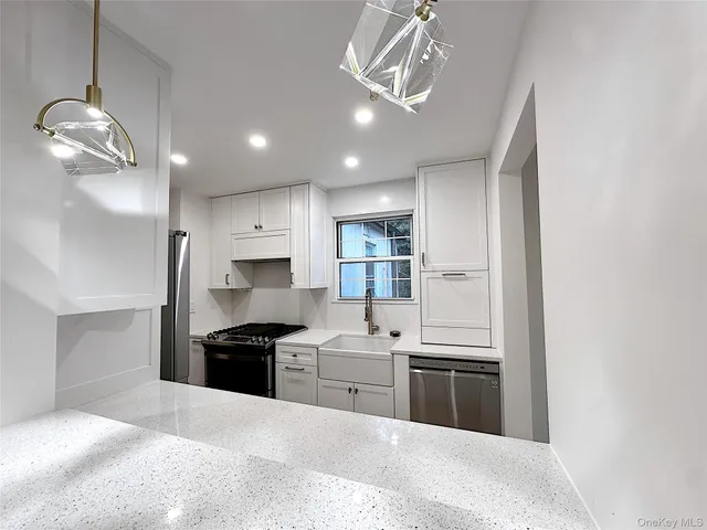 a kitchen with stainless steel appliances granite countertop a stove and a refrigerator