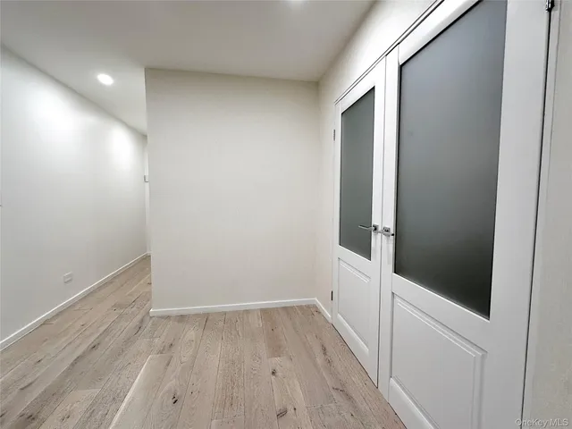 a view of a hallway with wooden floor and a hallway