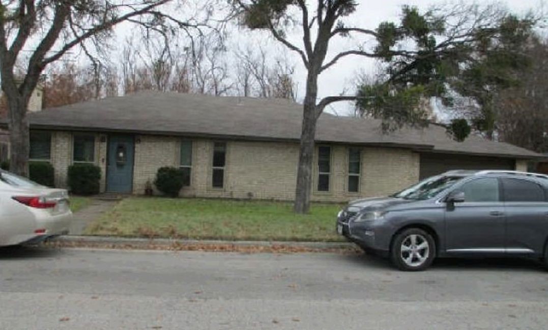 a view of a car parked in front of a house