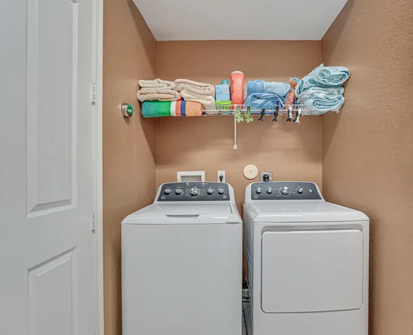 a front view of a house with a garden and trees