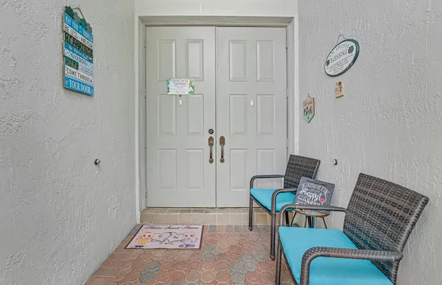 a view of a chair and tables in the patio next to a yard