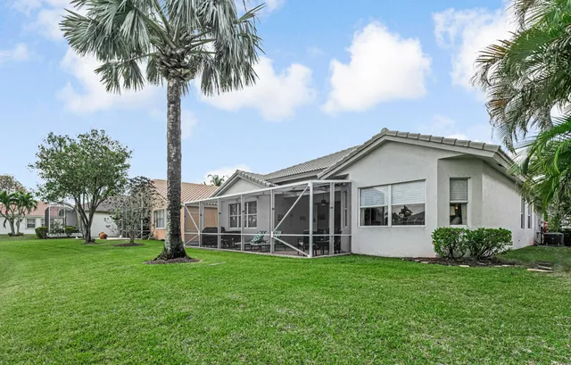 a view of a house with a yard and deck