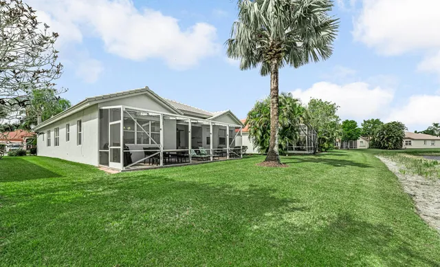 an aerial view of house with yard and lake view