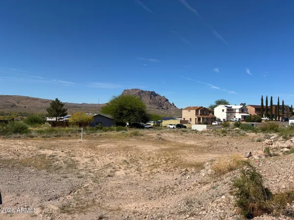 a view of a yard with wooden fence