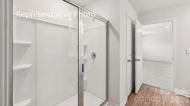 a bathroom with a glass shower door and a bathtub