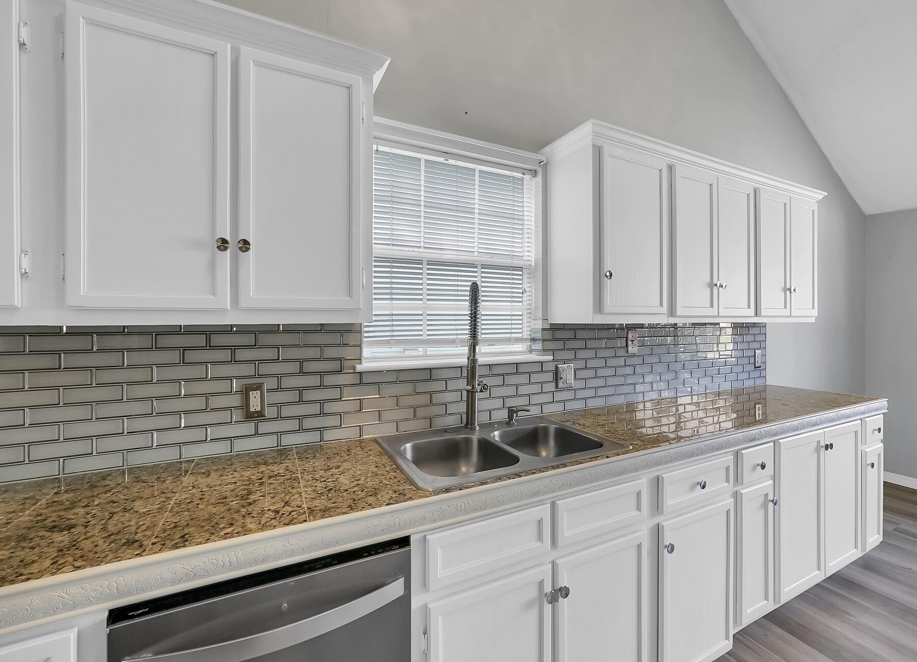 129 Wright Circle Niceville, FL 32578 - Photo 13 of 44 a kitchen with stainless steel appliances granite countertop white cabinets and white countertops with wooden floor