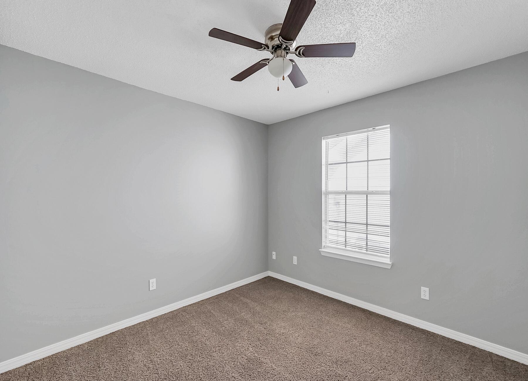 129 Wright Circle Niceville, FL 32578 - Photo 15 of 44 an empty room with windows and fan