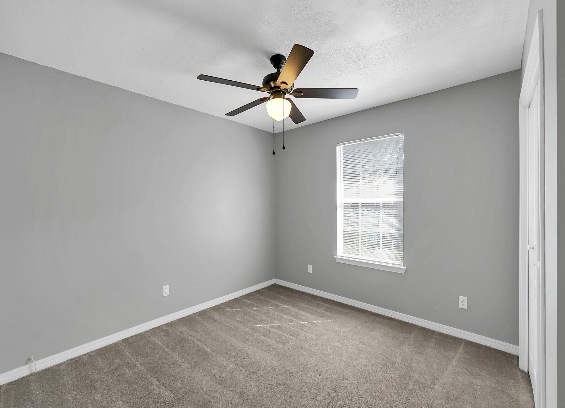 129 Wright Circle Niceville, FL 32578 - Photo 17 of 44 an empty room with a window and a fan