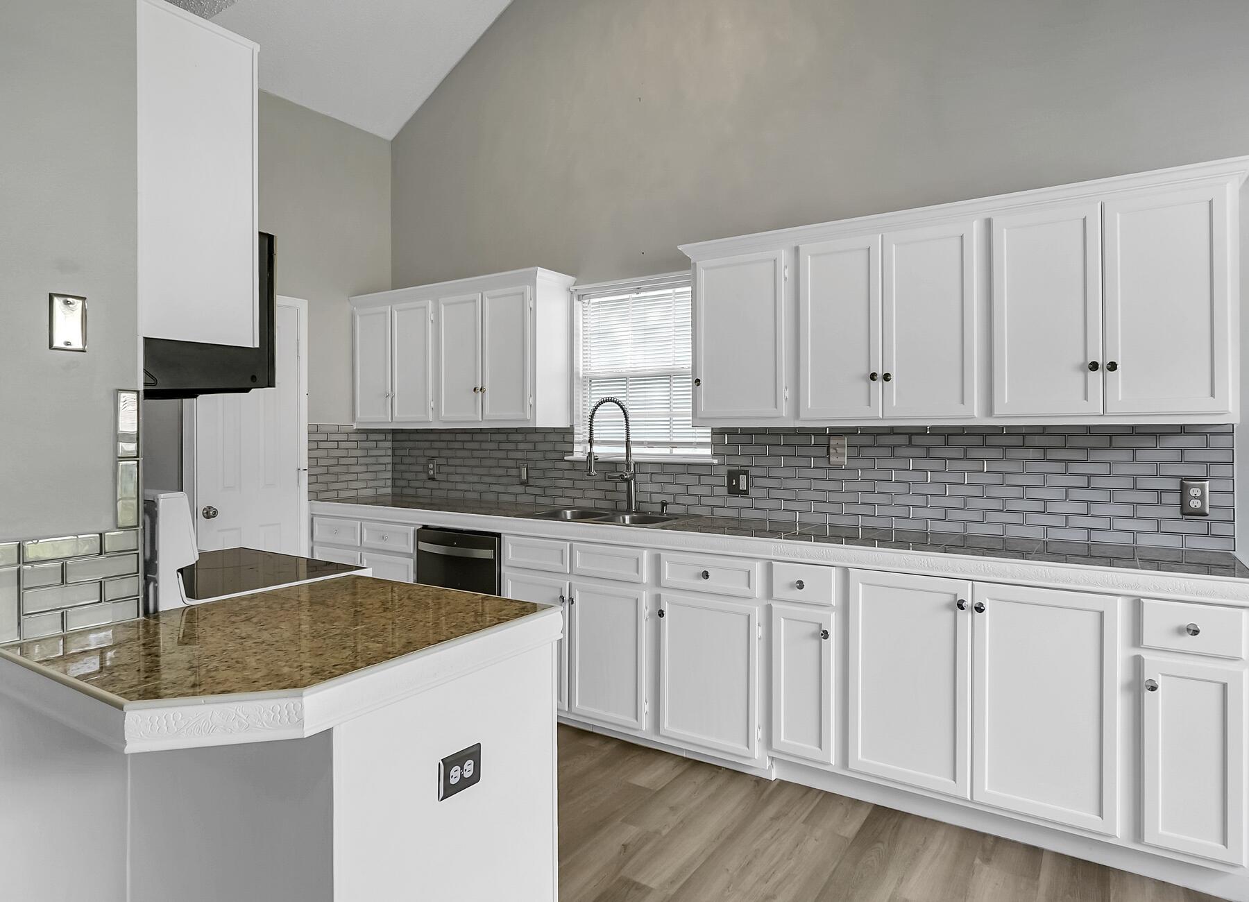 129 Wright Circle Niceville, FL 32578 - Photo 18 of 44 a kitchen with granite countertop a sink and cabinets