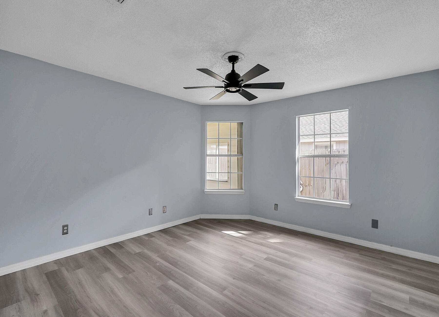 129 Wright Circle Niceville, FL 32578 - Photo 25 of 44 a view of empty room with wooden floor and fan