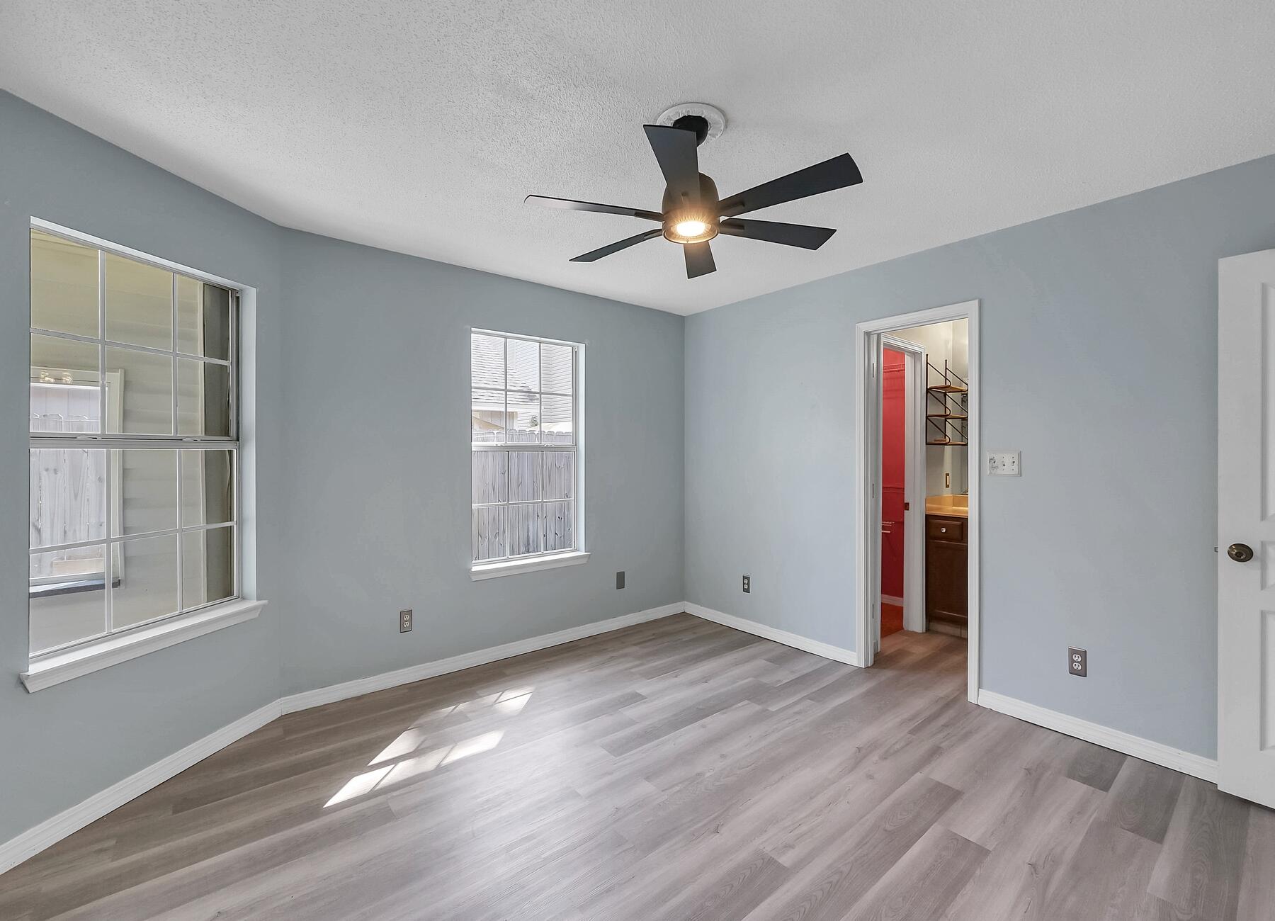 129 Wright Circle Niceville, FL 32578 - Photo 26 of 44 a view of empty room with wooden floor and fan