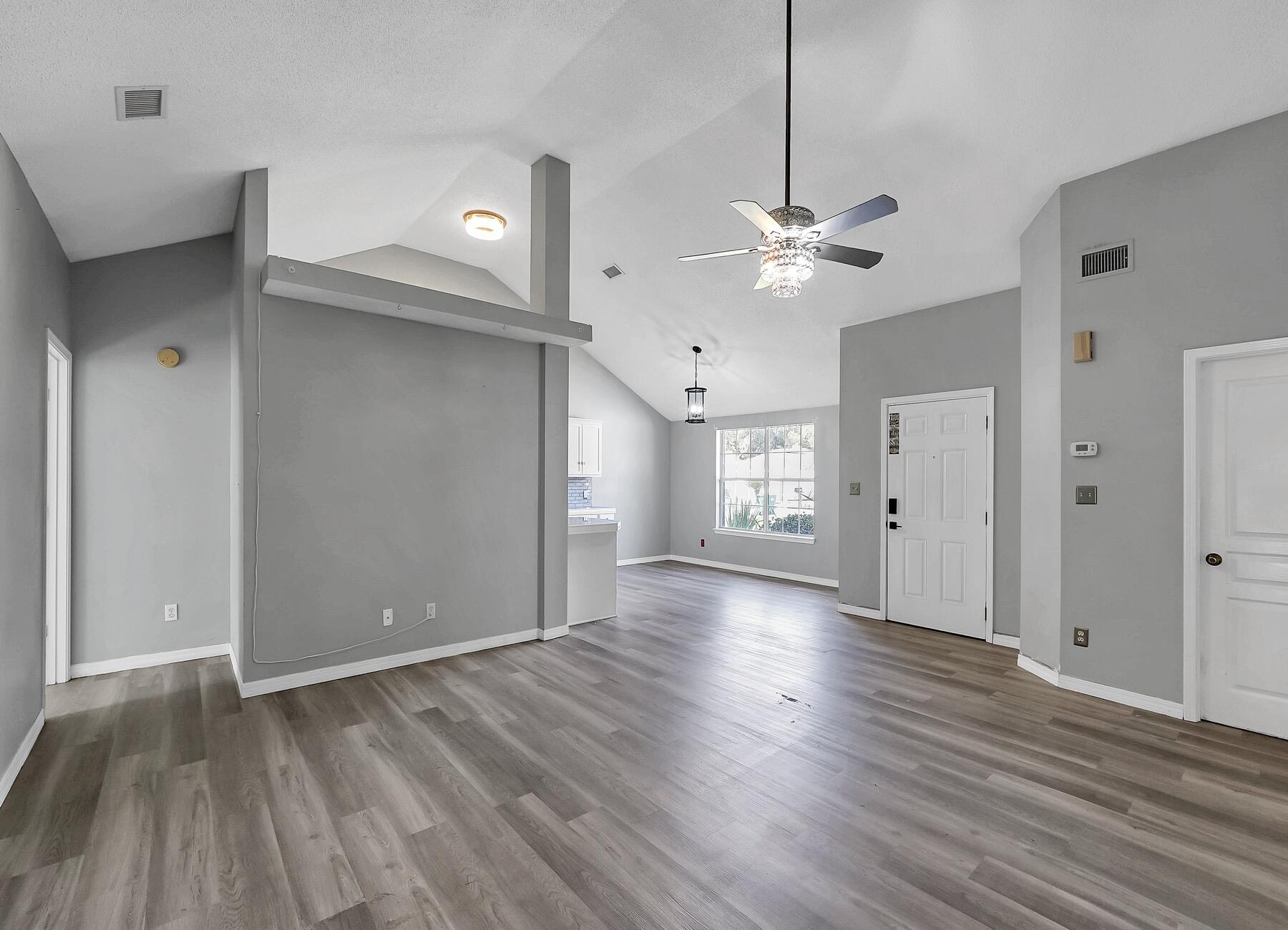 129 Wright Circle Niceville, FL 32578 - Photo 6 of 44 a view of an empty room with a window and a ceiling fan