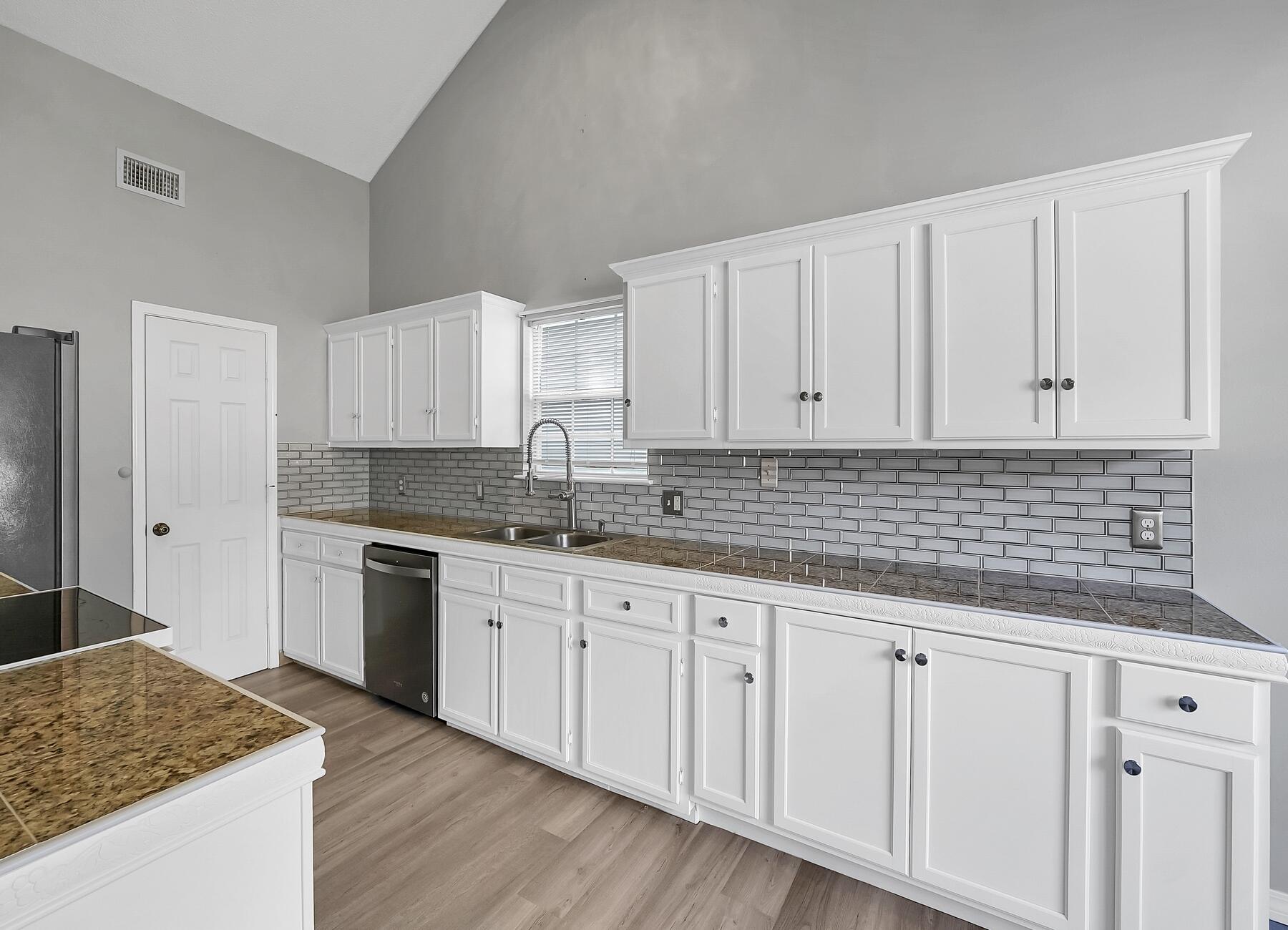 129 Wright Circle Niceville, FL 32578 - Photo 10 of 44 a kitchen with granite countertop white cabinets and sink