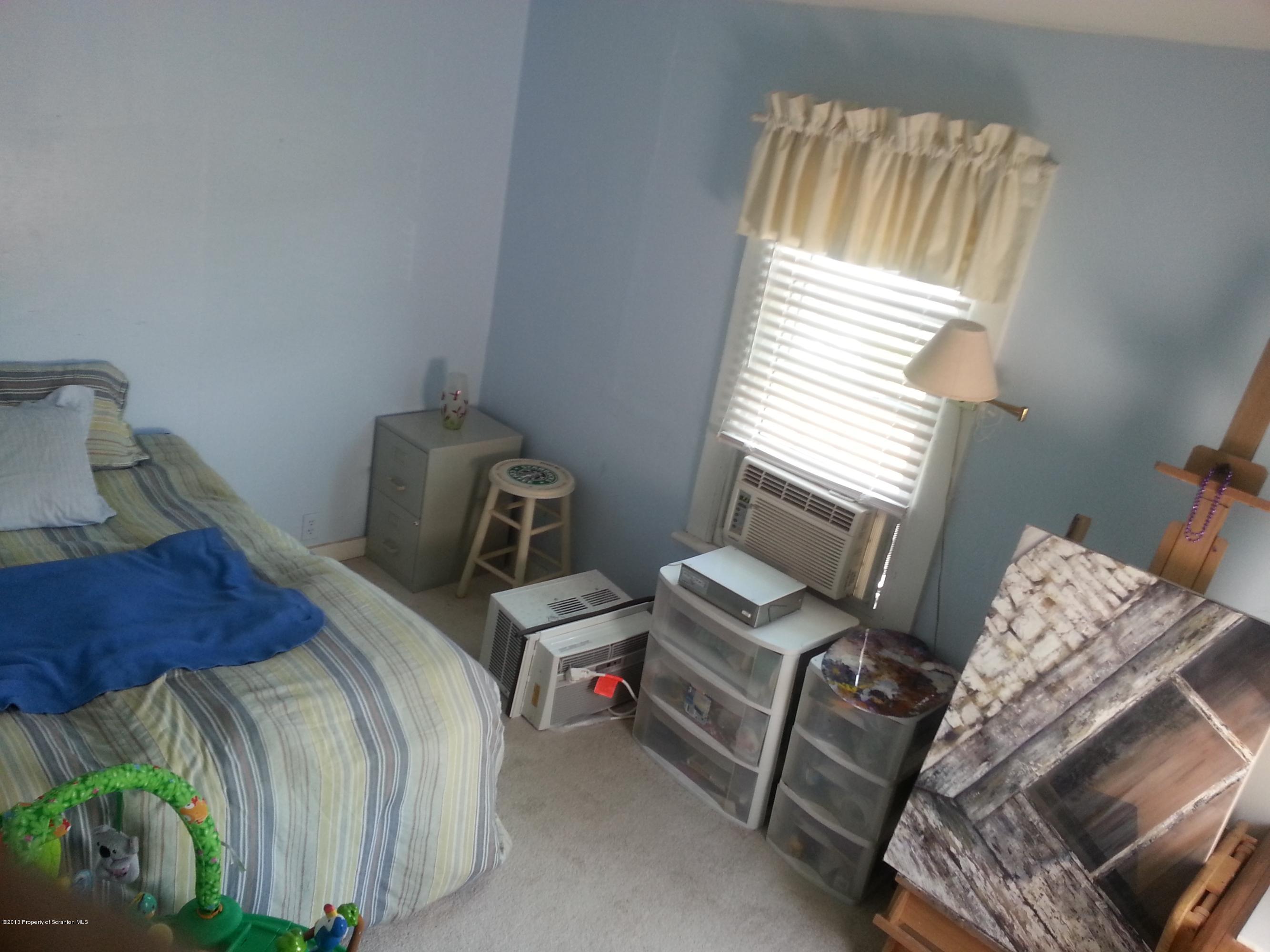 621 Electric Street Scranton, PA 18509 - Photo 19 of 29 a bed sitting in a bedroom next to a window