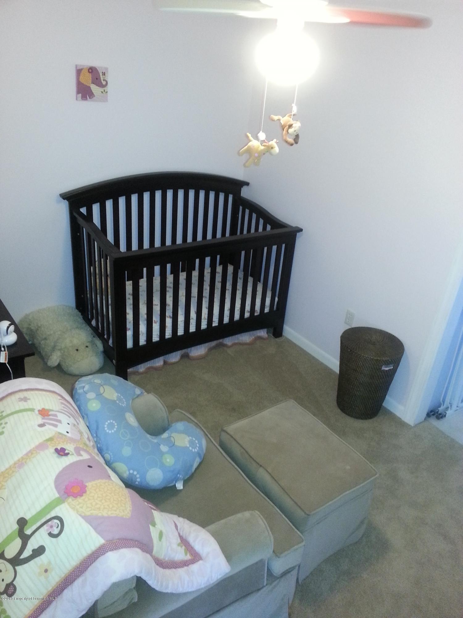 621 Electric Street Scranton, PA 18509 - Photo 20 of 29 a bed sitting in a bedroom next to a window