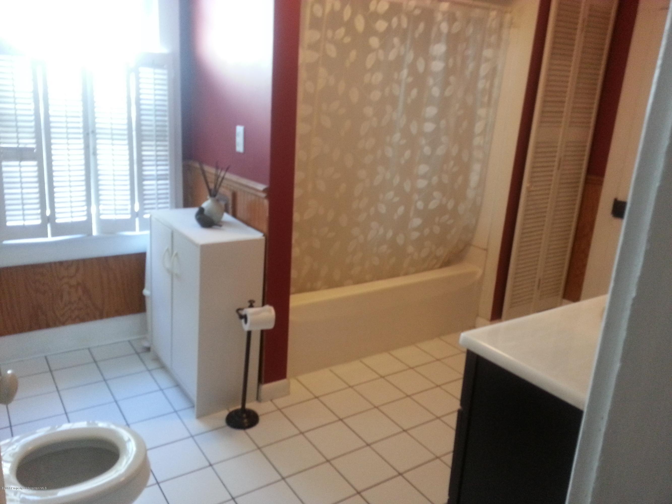 621 Electric Street Scranton, PA 18509 - Photo 22 of 29 a bathroom with a sink and a shower