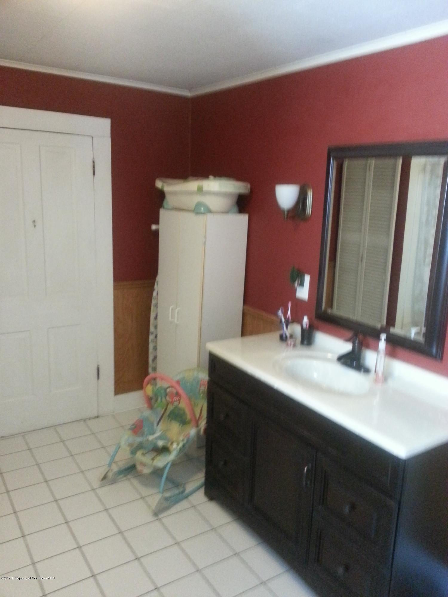 621 Electric Street Scranton, PA 18509 - Photo 23 of 29 a bathroom with a sink vanity and mirror