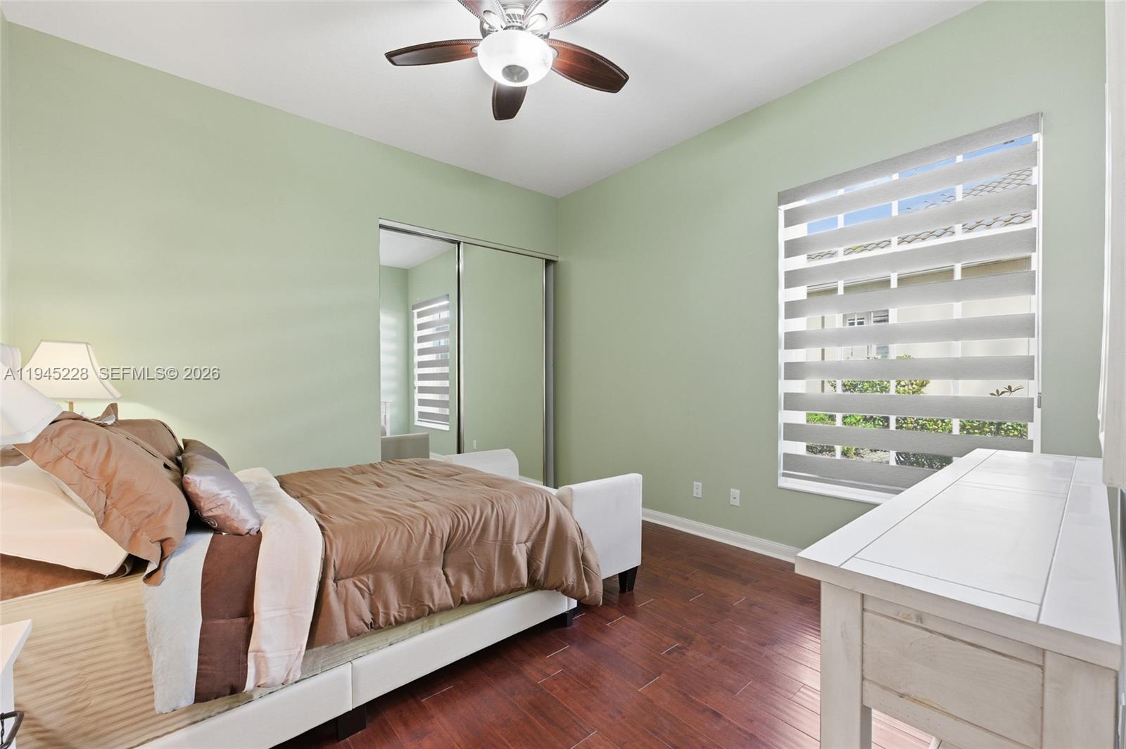 7646 Red River Road West Palm Beach, FL 33411 - Photo 41 of 69 a bedroom with a large bed and a chandelier